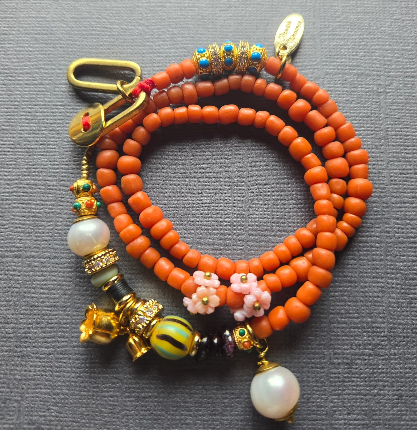 Beaded Charm Necklace in orange by Meredith Waterstraat