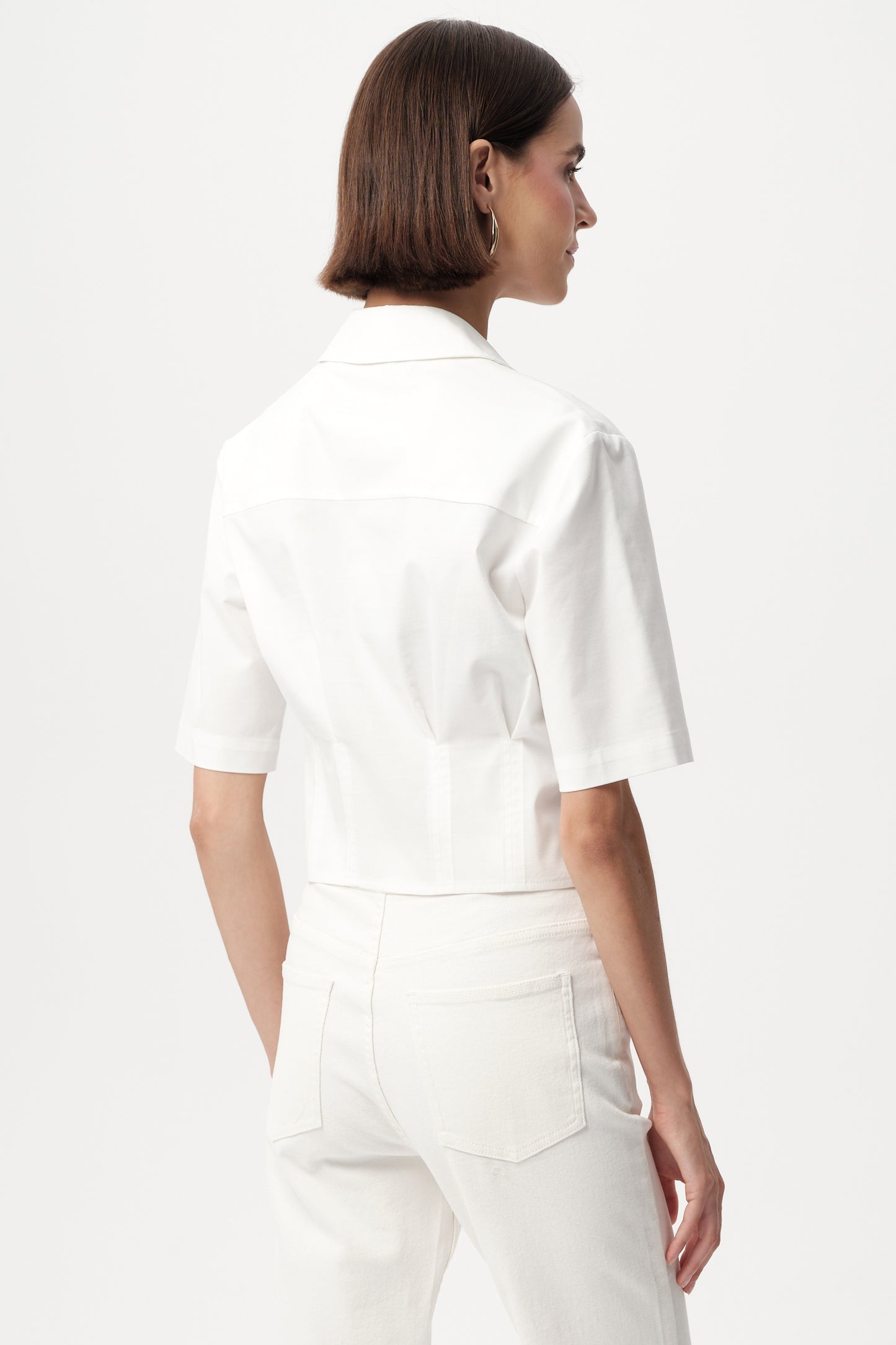 Model wearing white exquise top back view 