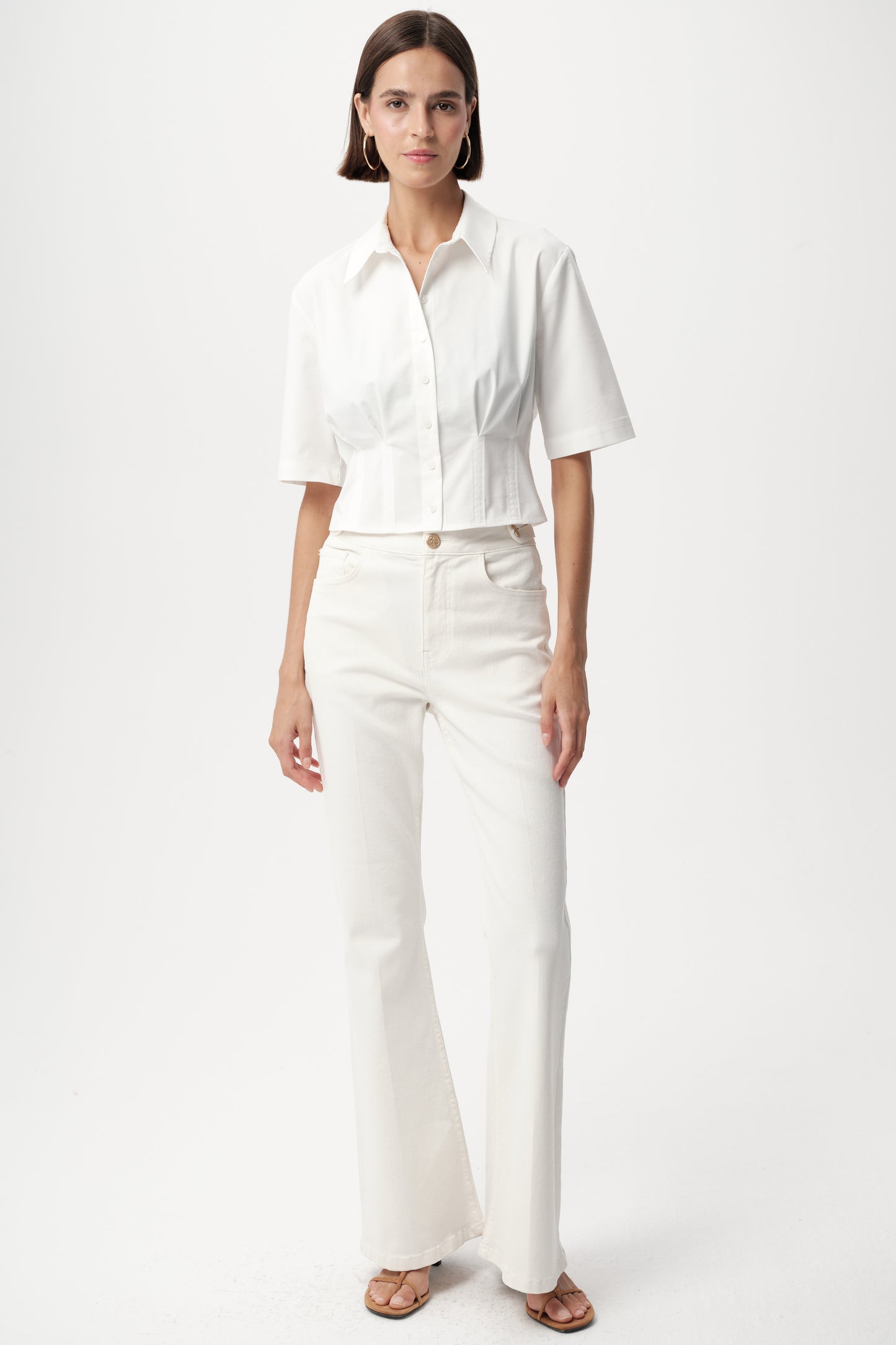 Model wearing white charm top by exquise