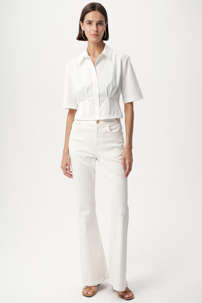 Model wearing white charm top by exquise