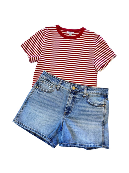 Red and white striped t-shirt with blue denim shorts on a white background