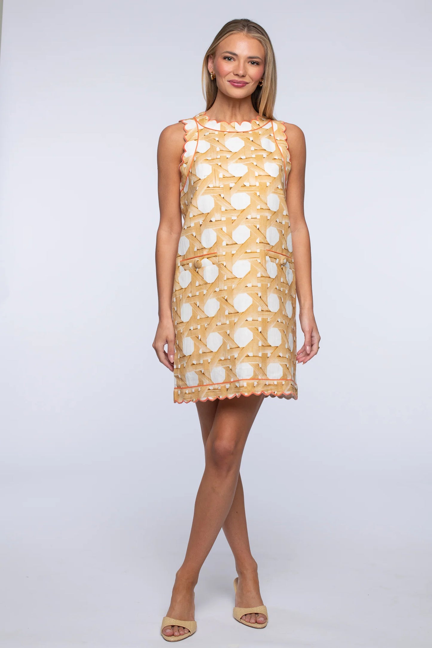 Woman wearing a patterned dress on a white background