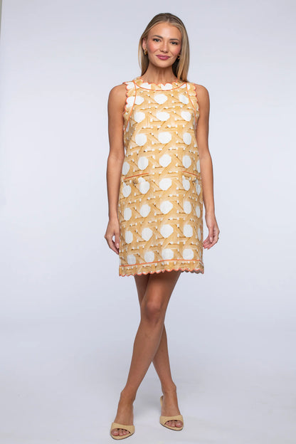 Woman wearing a patterned dress on a white background