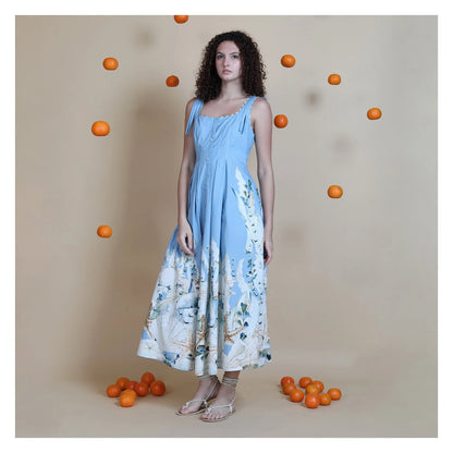 Blue cotton midi dress on model styled with sandals