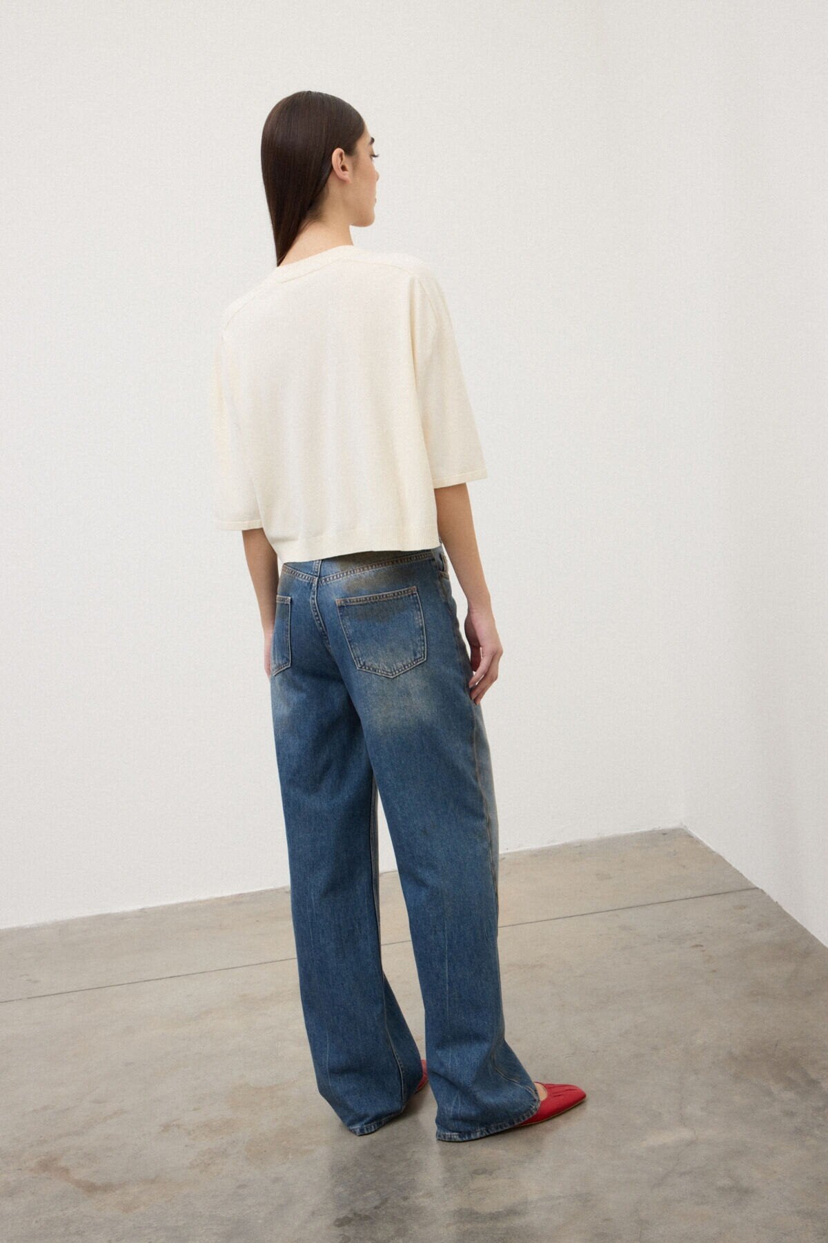 model wearing otod-ame v-neck sweater back view
