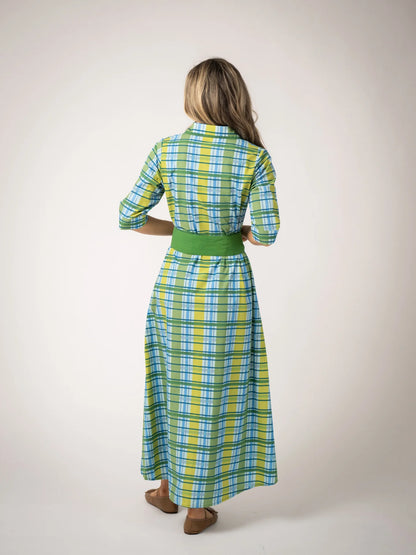 backview of model wearing green plaid maxi dress