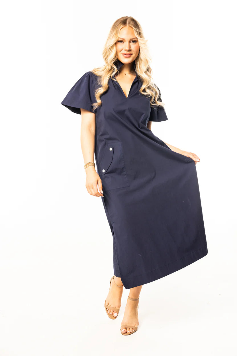 model wearing navy cotton poplin dress with sandals