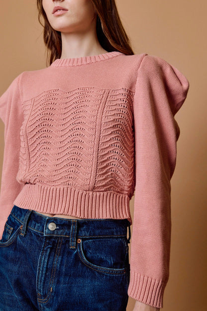 savvy womens boutique greenville south carolina close-up photo of model wearing a knitted cotton sweater with ribbed detailing paired with jeans