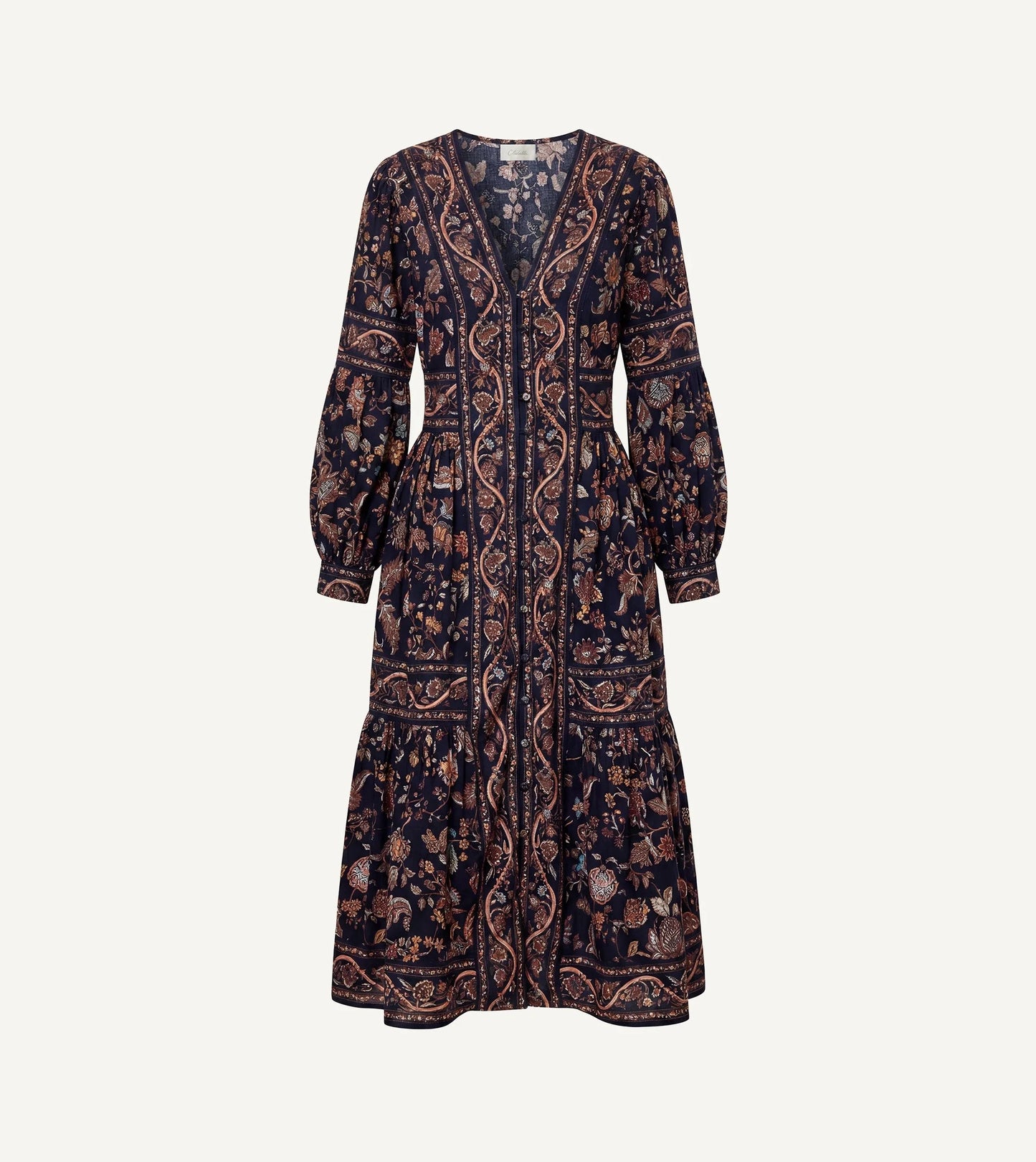 A long-sleeved midi dress with a dark navy blue base and an intricate paisley and floral pattern in brown, beige, and muted orange, shown against a plain off-white background.