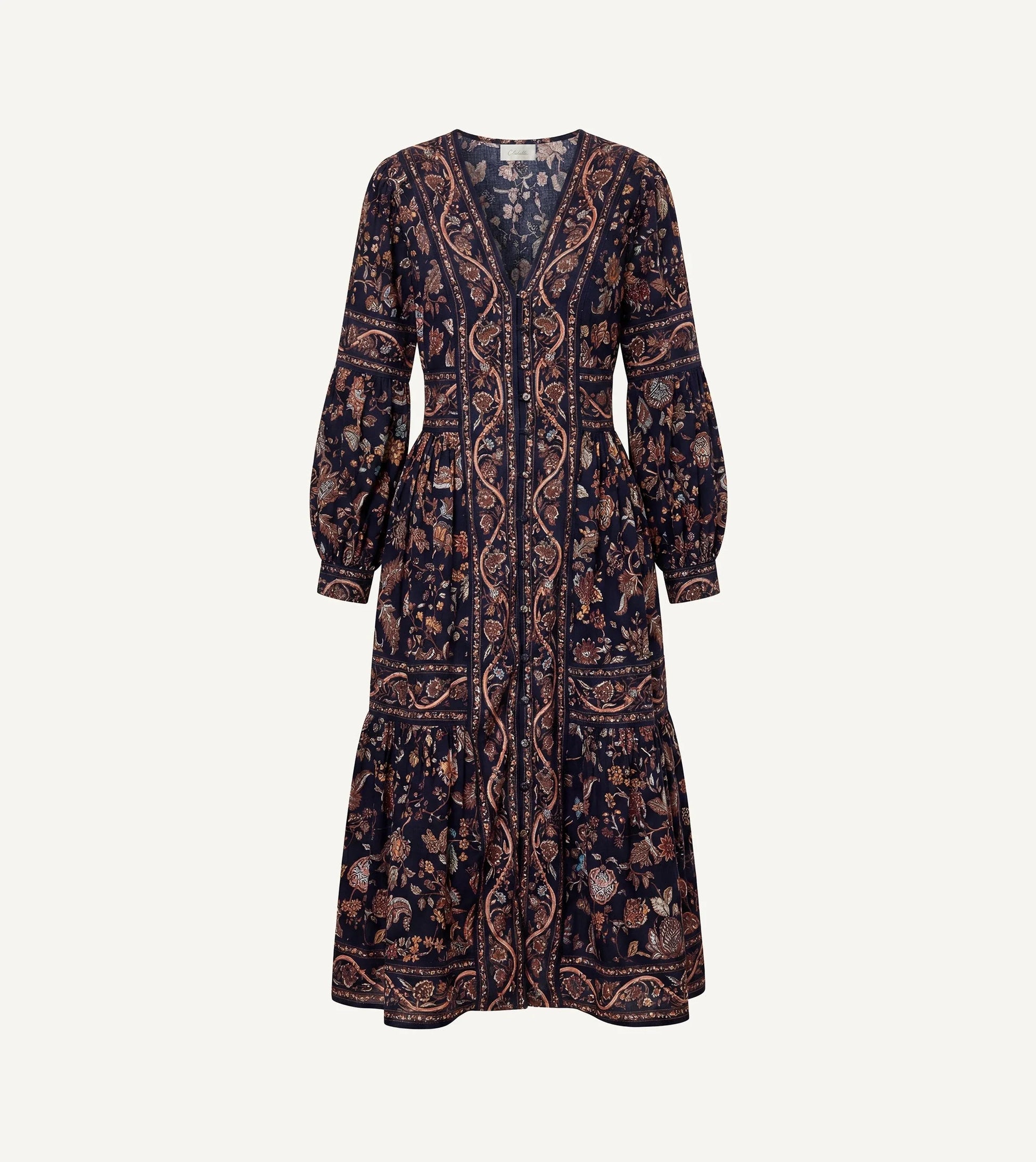 A long-sleeved midi dress with a dark navy blue base and an intricate paisley and floral pattern in brown, beige, and muted orange, shown against a plain off-white background.