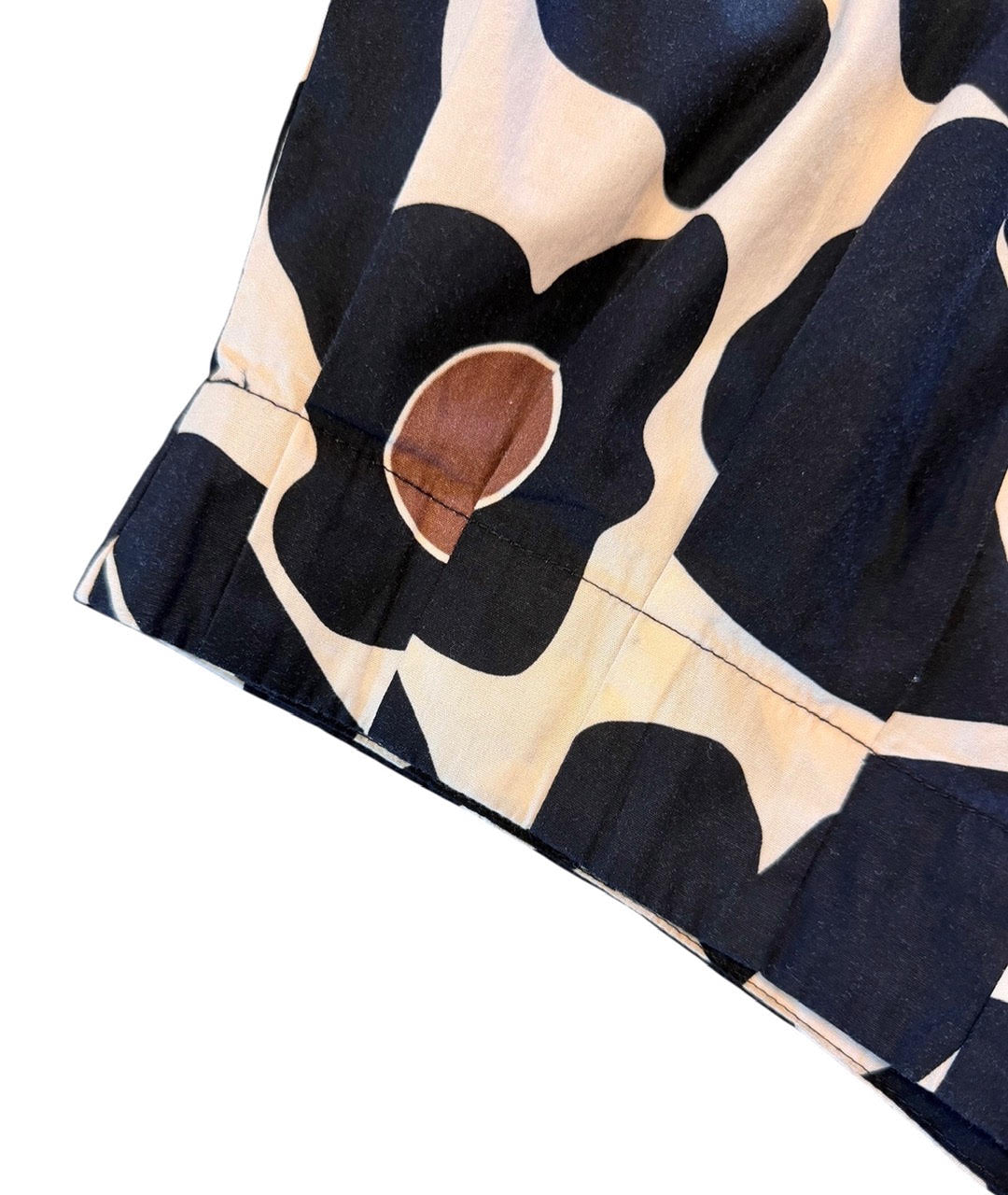 savvy | retail therapy close up of a printed floral top with pleated detailing along the hem
