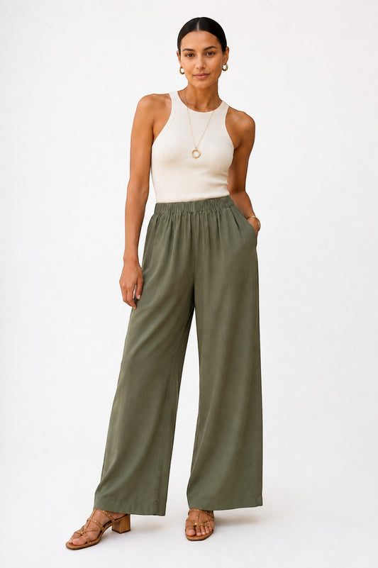 Model wearing SavVy | Retail Therapy Another Love rosemary shadow wide leg pants with a cream ribbed tank top