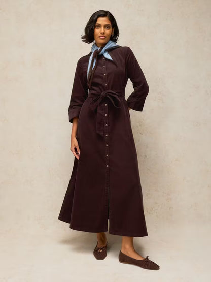savvy| retail therapy model wearing a slim fit dark brown corduroy shirtdress styled with a neck scarf for fall