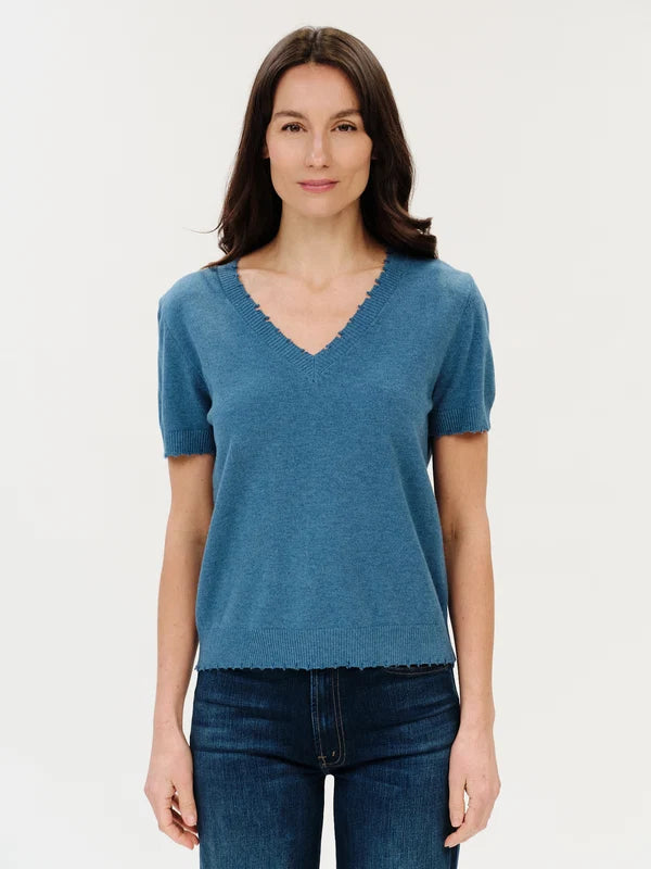 savvvy | retail therapy womens blue short sleeve sweater top with frayed hem on model styled with blue jeans 
