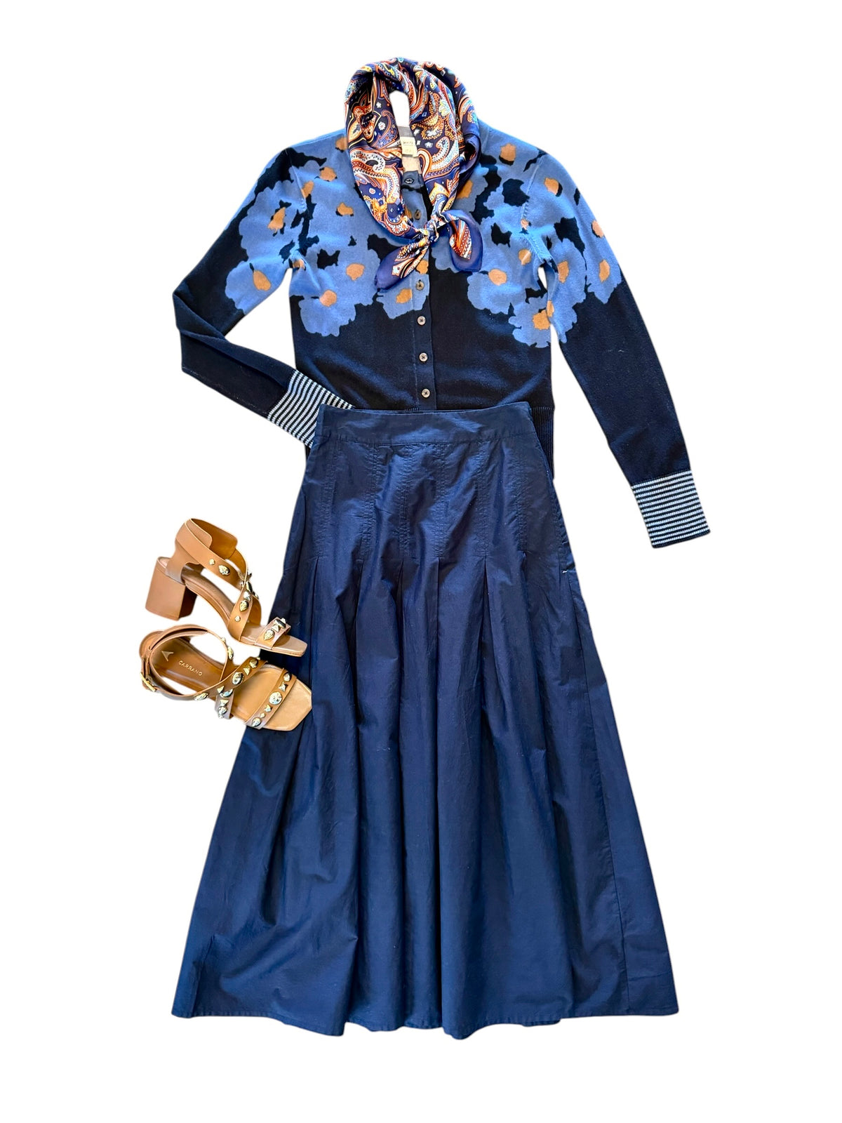 Savvy | retail therapy womens navy pleated skirt styled with a printed navy cardigan and heels and a neck scarf 